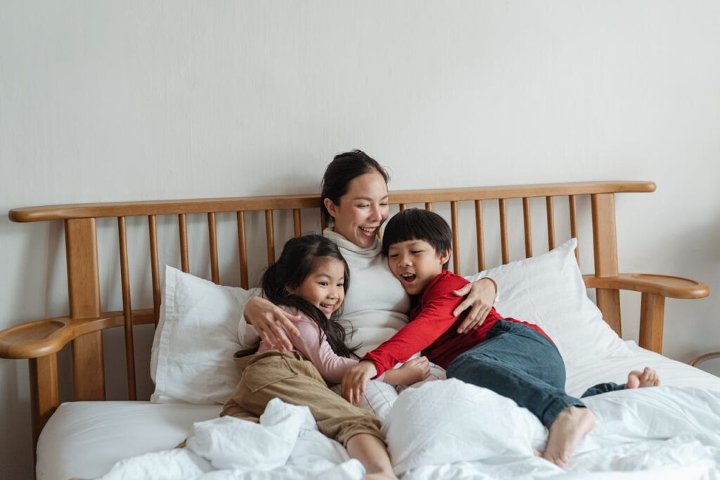 Family laying in bed smiling