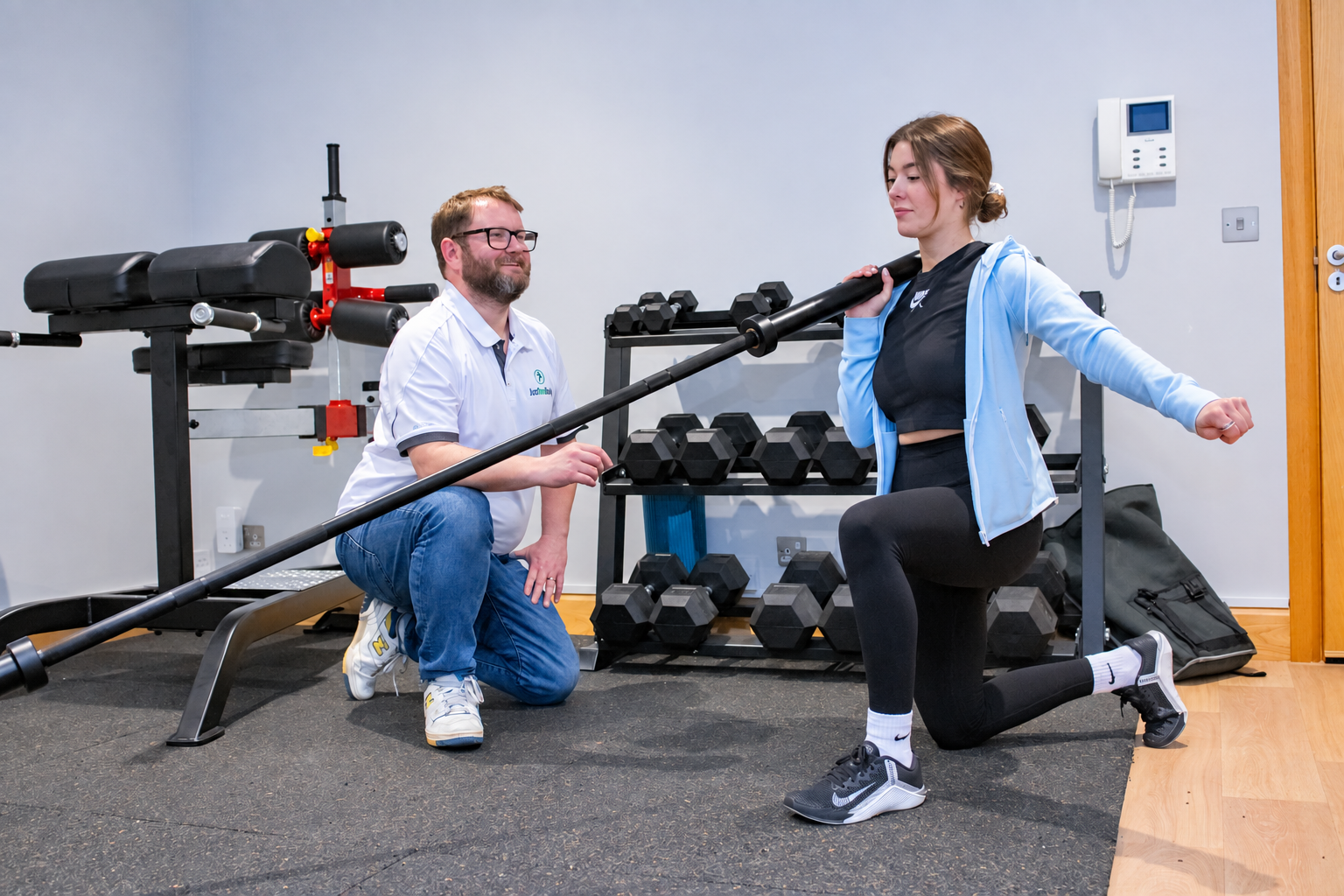 Athletic therapist supervising a strength exercise