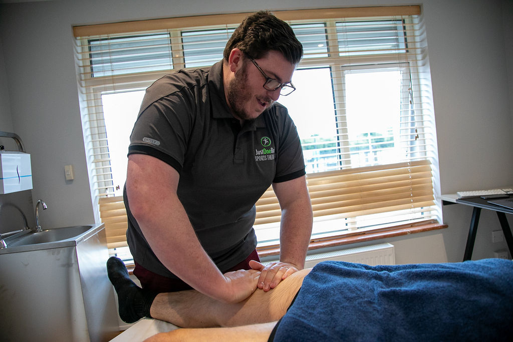 Brian O'Shea treating a patient's leg at Just One Body