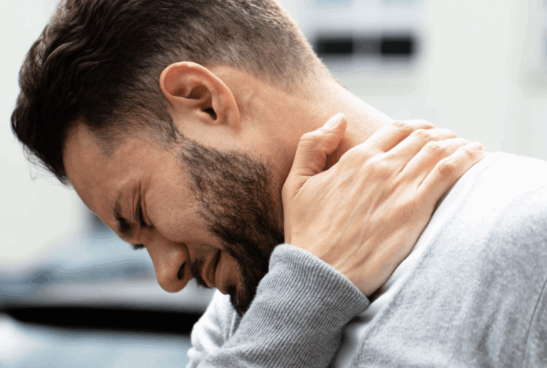 Man holding the back of his sore neck