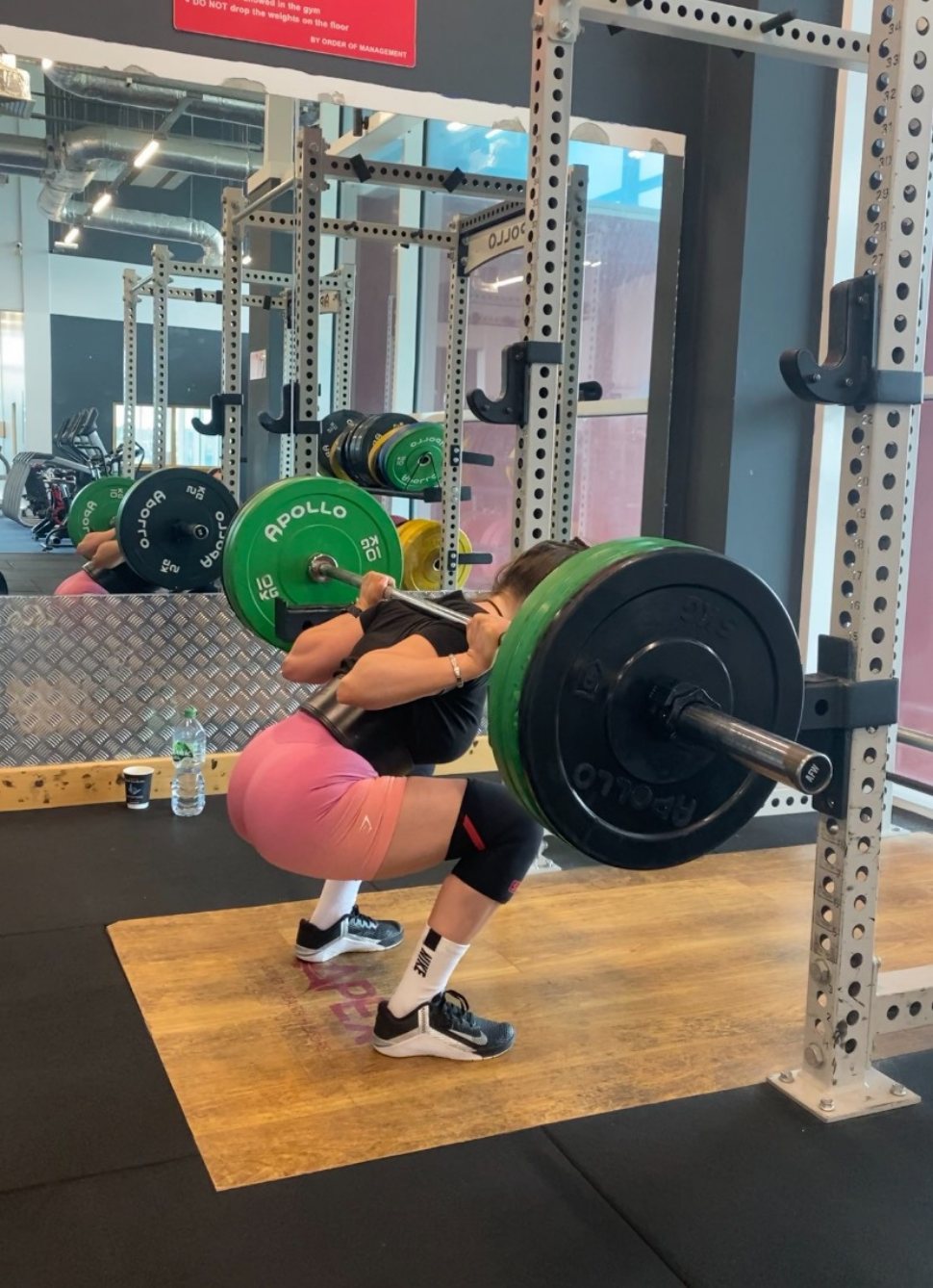 Michaela Gaffney, personal trainer, back squatting with a loaded barbell in the gym at Just One Body, New Ross
