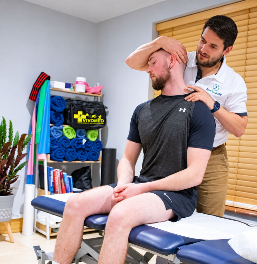 An osteopath assessing a patient’s neck and upper back at Just One Body, New Ross