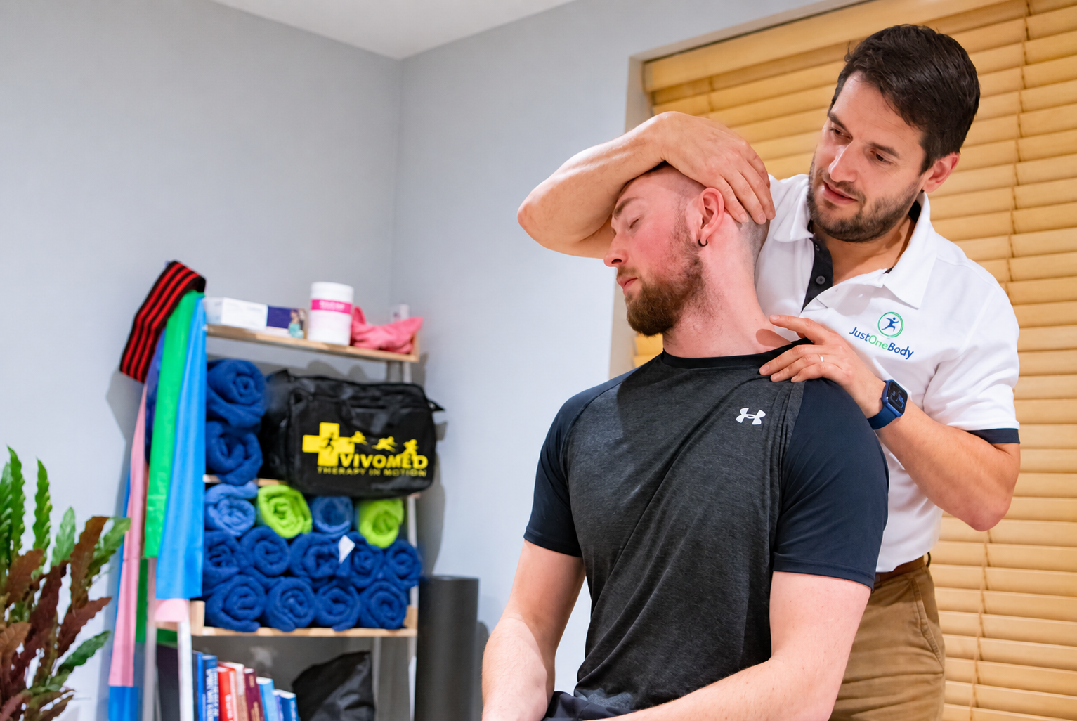 Osteopath assessing a patient’s neck
